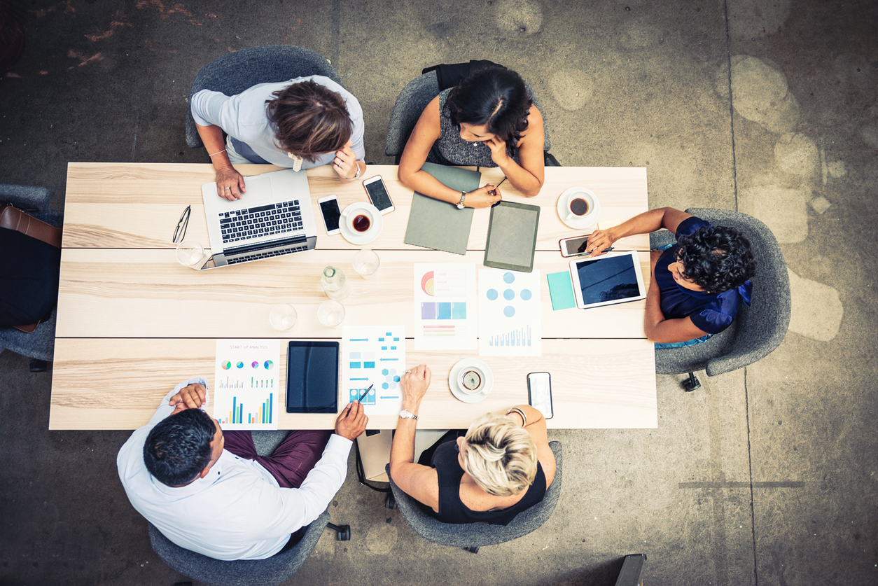 Salespeople at a table with documents